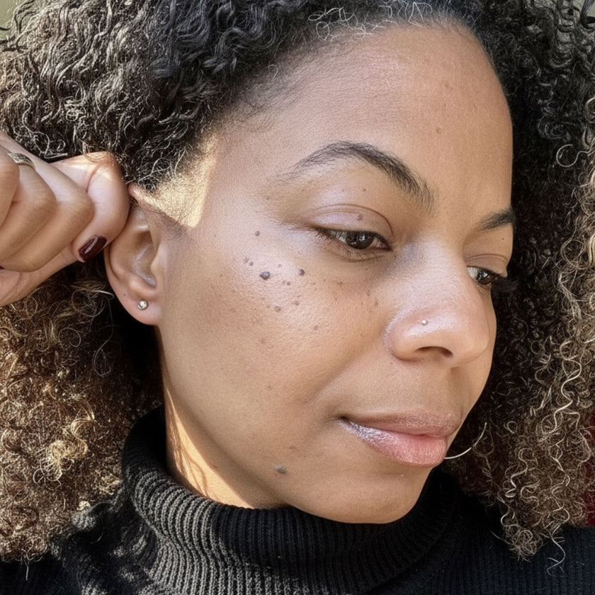 Model wearing minimalist 14kt solid gold pebble stud earrings for everyday look